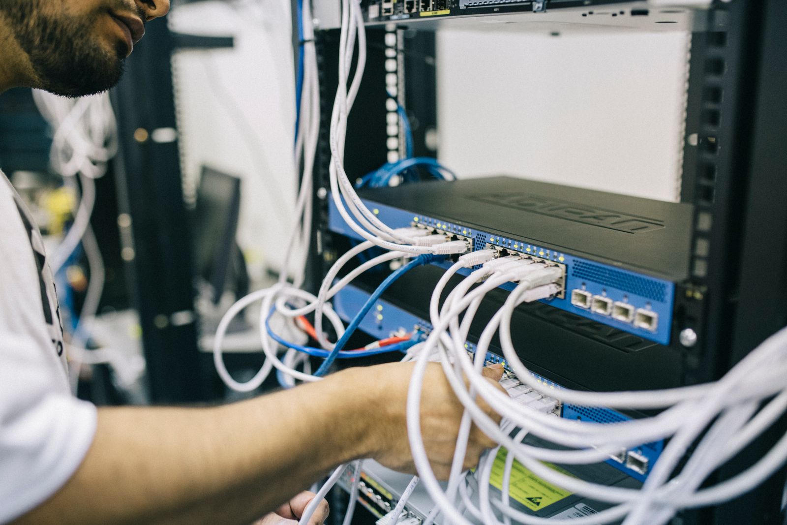 Technician inspecting live network switching equipment